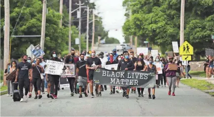  ?? ALYSSA STONE/USA TODAY NETWORK ?? Protesters march from Halloran Park through downtown Stoughton, Mass., to Town Hall for a Black Lives Matter protest June 10.