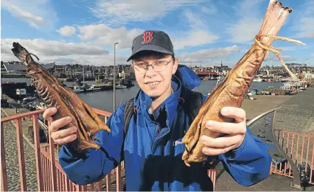  ?? Picture: Kim Cessford. ?? Hunor Deak with some of Arbroath’s famous smokies at the town’s harbour.