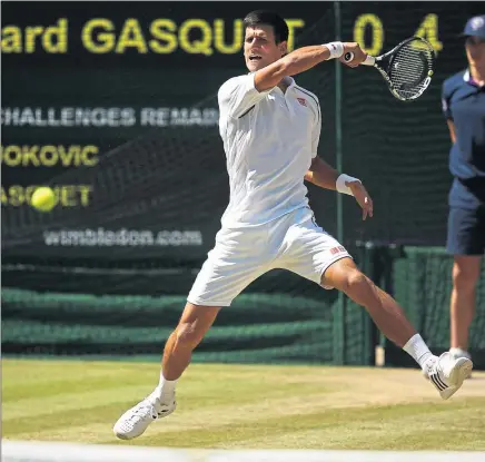  ??  ?? EYES ON THE PRIZE: Novak Djokovic lashes a forehand at Richard Gasquet en route to his third-consecutiv­e SW19 final