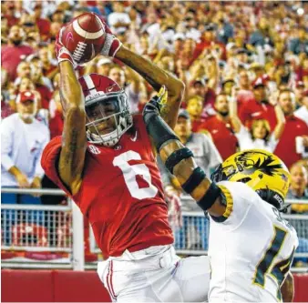  ?? THE ASSOCIATED PRESS ?? Alabama sophomore receiver DeVonta Smith goes up for a catch against Missouri on Oct. 13. Smith suffered a hamstring injury against the Tigers that forced him to sit out the win at Tennessee.