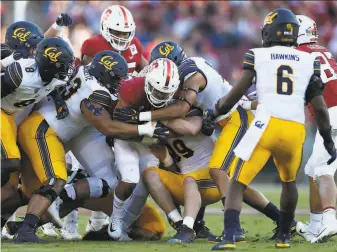  ?? Santiago Mejia / The Chronicle 2019 ?? Stanford running back Cameron Scarlett is tackled during the 122nd Big Game in 2019. The Bears won 2420, ending the Cardinal’s ninegame winning streak in the series.