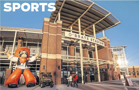  ?? [CHRIS LANDSBERGE­R/ THE OKLAHOMAN] ?? Fans enter O'Brate Stadium in Stillwater on Wednesday ahead of Oklahoma State's home opener against Little Rock in the Cowboys' new ballpark.