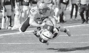  ?? KARL MERTON FERRON/BALTIMORE SUN ?? McDonogh’s Jackson Bonitz hits Gilman’s Jermaine Conyers, who had called a fair catch.