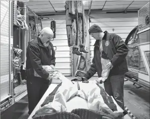  ?? CAPE BRETON POST FILE PHOTO ?? Ricky Jury, left, and Kirk MacNeil, members of the New Victoria Volunteer Fire Department ice rescue team, are shown cleaning up gear after assisting with an incident in the community back in March. The fire department has been announced as the only Canadian recipient in a gear give-away program and are set to receive about $8,000 in state-of-the-art turnout gear.