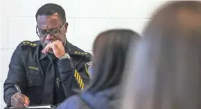  ?? JOURNAL SENTINEL EBONY COX / MILWAUKEE ?? Acting Police Chief Jeffrey Norman jots down notes Saturday at Silver Spring Neighborho­od Center as he listens to community members.