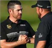  ?? Christophe­r Lee/Getty Images ?? Louis Oosthuizen, left, shares well-wishes with playing partner Shane Lowry.