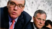  ?? ALEX WONG / GETTY IMAGES ?? Committee Chairman Sen. Richard Burr (right), R-N.C., listens as Committee Vice Chairman Sen. Mark Warner (left), D-Va., speaks during a hearing Wednesday before the Senate Intelligen­ce Committee on Capitol Hill.