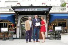  ?? PHOTO PROVIDED ?? Saratoga Springs Preservati­on Foundation Board President Matthew Veitch and Executive Director Samantha Bosshart, present Adelphi Hotel owner Toby Milde with their Preservati­on Recognitio­n Award.