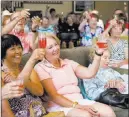  ??  ?? Sumiko Tatsue, left, and Carol Sworsy, center, toast World War II veteran Gene Stephens on Thursday.