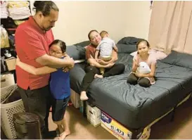  ?? JENNIFER SINCO KELLEHER/AP 2022 ?? Kona Purdy and his family gather last month in one of two bedrooms they share in a house they rent with extended family in Kapolei, Hawaii. The family moved to Las Vegas in 2017 to escape Hawaii’s high cost of living but returned last year.