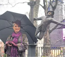  ?? PA. Picture: ?? Patricia Ward, widow of Gene Kelly, alongside a statue of the Hollywood legend.