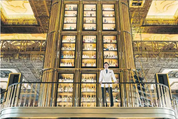  ?? FRANZ NAVARRETE/BLOOMBERG ?? Singapore’s Atlas has a massive gin tower and is a breathtaki­ng spot to sip a martini while taking in the soaring art deco atrium.