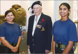  ?? WAYNE EMDE/Special to The Daily Courier ?? In front of the display case that houses his uniform and medals, retired Bombardier Herbert (Buck) Rogers poses with cadets Vrinda Vyas and Mehakpreet Boparai, both from Winnipeg, during a visit to the Vernon Cadet Museum.