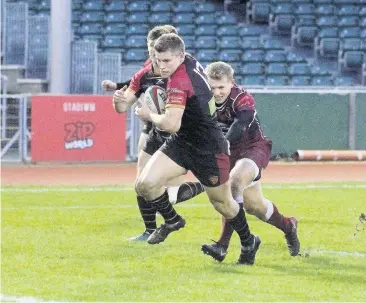  ??  ?? ● Tom Hughes, pictured in previous action, narrowed the gap with a try in the corner