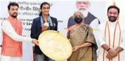  ?? — PTI ?? Sports minister Anurag Thakur (left) and finance minister Nirmala Sitharaman (second from right) felicitate Tokyo bronze medallist P. V. Sindhu in New Delhi on Tuesday. Union minister G. Kishan Reddy (right) is also seen.