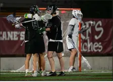  ?? HELEN H. RICHARDSON — THE DENVER POST ?? Mountain Vista’s Joel Palasz (9) is congratula­ted for his goal against Valor Christian goalkeeper Buck Cunningham, in back, during the first half of the Class 5A state lacrosse championsh­ip game at Peter Barton Stadium on Monday.