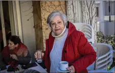  ?? ?? An elderly woman stands at an open care centre for elderly people, in Athens.