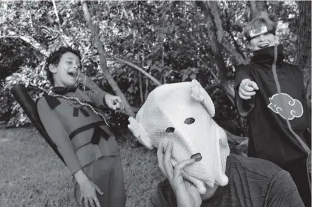  ?? ?? Nicolas Lund-Larson, center, and his Turkey Mask are the butt of a joke by Mathieu Parry, 10, left, and Nicolas’ son, Samuel ‘Sam’ Lund-Larson,12, right.