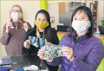  ?? Picture: PAUL CARRACHER ?? MARKETABLE PROJECT: Centre for Participat­ion receptioni­st Susan Griffiths, migrant liaison officer Cecile Vence and English and micro-business student Phuong Dung Ha with masks Ms Ha is making.