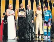  ?? AFP ?? French director Julia Ducournau (centre) poses on stage after her win for Titane in Cannes on Sunday.