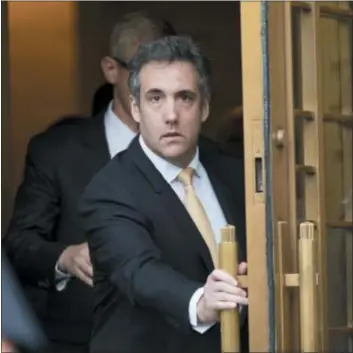  ??  ?? Michael Cohen leaves federal court, Tuesday in New York. Cohen pleaded guilty to charges including campaign finance fraud stemming from hush money payments to porn actress Stormy Daniels and ex-Playboy model Karen McDougal.