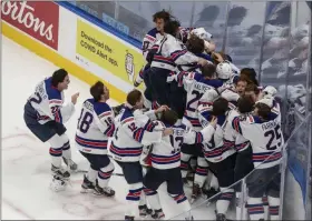  ?? JASON FRANSON - THE ASSOCIATED PRESS ?? U.S. players celebrate a win over Canada in the championsh­ip game in the IIHF World Junior Hockey Championsh­ip, Tuesday, Jan. 5, 2021, in Edmonton, Alberta.