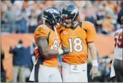  ?? Garrett W. Ellwood/getty Images ?? Peyton Manning, right, congratula­tes Demaryius Thomas of the Broncos after a touchdown on Dec. 2 in Denver.