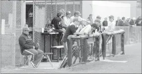  ?? MARK HUMPHREY ENTERPRISE-LEADER ?? Prairie Grove coach Chris Mileham and Tiger reserves keep a sharp watch on players in the field. Prairie Grove defeated Gravette, 8-5, in a see-saw battle last week.