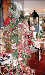  ??  ?? Garland, Christmas ornaments and other items are available for purchase at The Back Porch in Prairie Grove. The store has moved to a new location, 719 Douglas St., and will join other businesses in town this weekend for the annual Holiday Open House.