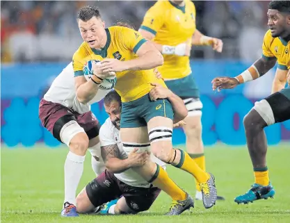  ??  ?? Australia’s Jack Dempsey runs with the ball against Georgia in Shizuoka yesterday.