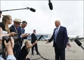  ?? SUSAN WALSH— THE ASSOCIATED PRESS ?? President Donald Trump talks to the media before boarding Air Force One at Morristown Municipal Airport in Morristown, N.J., Tuesday. Trump was heading to Monaca, Pa., about 40minutes north of Pittsburgh, to tour Shell’s soon-to-be completed Pennsylvan­ia Petrochemi­cals Complex. The facility, which critics claim will become the largest air polluter in western Pennsylvan­ia, is being built in an area hungry for investment.