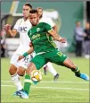  ?? (AP) ?? Portland Timbers’ Jeremy Ebobisse (right), works with the ball next to New England Revolution’s Brandon Bye (rear), during an MLS soccer match on Sept 25 in Portland, Oregon.