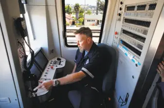  ??  ?? Train operator Kirk Paulsen at the controls of a new BART train. BART began testing on the first batch of 10 cars last spring and has encountere­d scores of glitches.