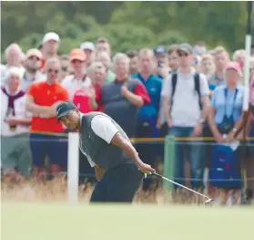  ?? AP FOTO/ ALASTAIR GRANT ?? BEST IN YEARS. Tiger Woods of the US watches his birdie putt on the 8th green during the third round of the British Open.