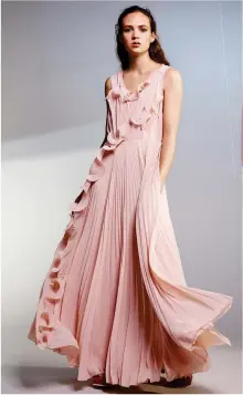  ??  ?? A model wears a pink gown from the H&M Conscious Exclusive collection.