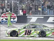  ?? LARRY PAPKE — ASSOCIATED PRESS ?? Kyle Busch waves the checkered flag after taking the NASCAR Cup Series win in Fort Worth, Texas, on Sunday.