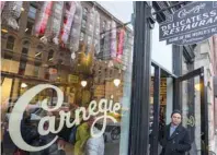  ?? — AFP ?? A man stands at the door to meet customers on November 30, 2018 at the Carnegie Deli pop-up in New York.
