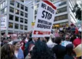  ?? CRAIG RUTTLE — THE ASSOCIATED PRESS ?? People gather in support of unsigned NFL quarterbac­k Colin Kaepernick on Wednesday outside NFL headquarte­rs New York. in