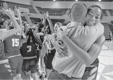  ?? Jerry Baker ?? Barbers Hill junior post Charli Collier, right, shares a hug with coach Tri Danley after their victory against Georgetown in a regional final Saturday at Delmar Fieldhouse.