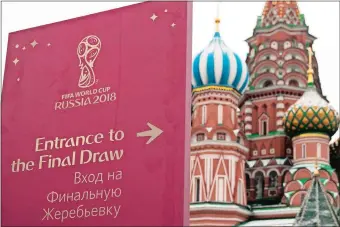  ?? PAVEL GOLVKIN/AP PHOTO ?? A signpost directing people to the entrance of the World Cup Final Draw is placed on the Red Square, with the St. Basil cathedral in the background, on Thursday in Moscow. The final draw for the 2018 FIFA World Cup will take place on Friday in the concert hall of the Kremlin Palace.