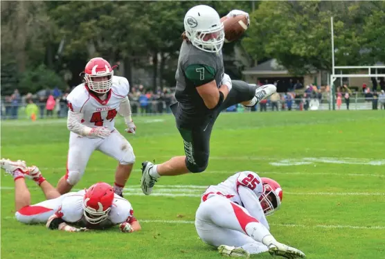  ?? | PATRICK GLEASON/FOR THE SUN-TIMES ?? Vanderbilt-bound SamBrodner leaps to score one of his three touchdowns in a home-field victory by GlenbardWe­st against Hinsdale Central.