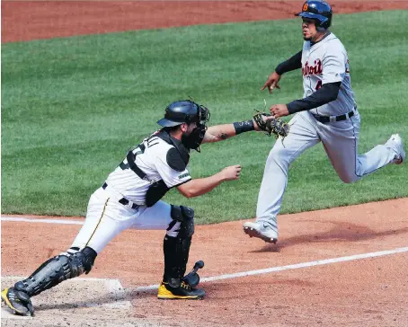  ?? THE ASSOCIATED PRESS ?? Pirates catcher Francisco Cervelli takes the throw from third baseman Colin Moran to force out Detroit’s Dixon Machado during the top of ninth inning on Thursday in Pittsburgh. Corey Dickerson’s solo shot in the home half of the inning gave the Pirates...