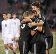  ??  ?? Boyertown players Alex Kidwell, left, Nathan Reinhard, Nik Verma and Kyle Sheahan embrace following the final whistle after Boyertown defeated Pottsgrove in the PAC boys soccer championsh­ip Thursday at Owen J. Roberts.