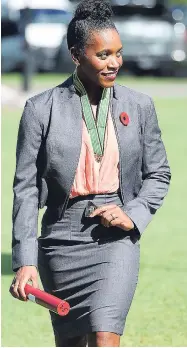  ?? LIONEL ROOKWOOD/PHOTOGRAPH­ER PHOTO BY ?? Olympian Alia Atkinson walks away in elation after being awarded the Order of Distinctio­n in the rank of commander at the Presentati­on of National Honours and Awards held at King's House yesterday.