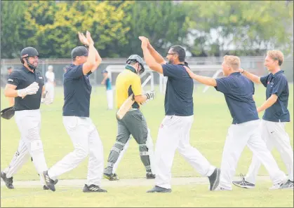  ??  ?? WRMK Kerikeri spin bowler Bronson Silvera is congratula­ted by his teammates after taking an Onerahi wicket at Kerikeri High School on Saturday afternoon. The rain interrupte­d match eventually ended as a draw after six hours of play.