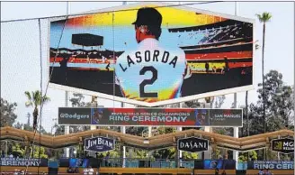  ?? Luis Sinco Los Angeles Times ?? THE DODGERS pay tribute to former manager Tommy Lasorda before their home opener. The longtime manager, who brought the team two World Series titles, died Jan. 7 at 93.