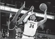  ?? [JOHN MINCHILLO/THE ASSOCIATED PRESS] ?? Cincinnati’s Kyle Washington shoots over Mississipp­i State’s Abdul Ado. MARYLAND 76, CATHOLIC 59: