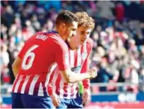  ?? Agence France-presse ?? Atletico Madrid’s Antoine Griezmann (right) celebrates with team-mate Koke after scoring against Levant during their Spanish League match in Madrid on Sunday.
