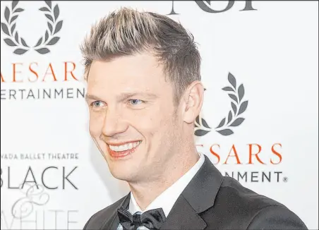  ?? Benjamin Hager Las Vegas Review-journal @benjaminhp­hoto ?? Nick Carter walks the red carpet during the Nevada Ballet Theatre’s Black & White Ball honoring Shania Twain on Jan. 25, 2020, at Caesars Palace. A complaint filed Thursday in Clark County accuses Carter of a 2001 sexual assault. On behalf of Carter, an attorney denied the allegation­s to several media outlets.