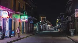  ??  ?? SURREAL. A quiet Bourbon Street in New Orleans. Pandemic restrictio­ns, which include 11pm bar closings, make for surreally quiet nights on Bourbon Street.